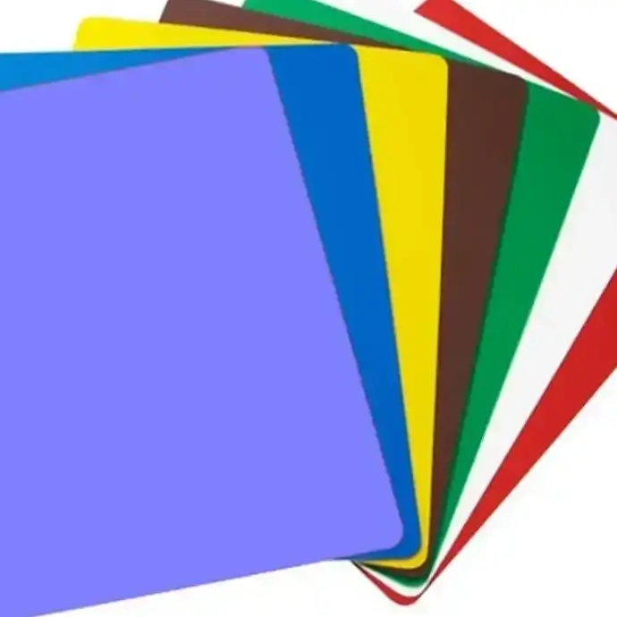 Colour coded chopping boards for food preparation in a commercial kitchen.