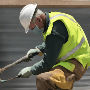 Construction worker cleaning guano
